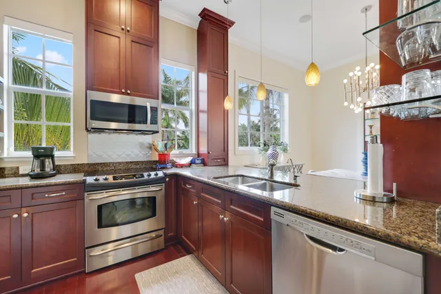 a kitchen with stainless steel appliances a stove sink and microwave