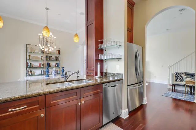 a kitchen with stainless steel appliances granite countertop a refrigerator and a sink