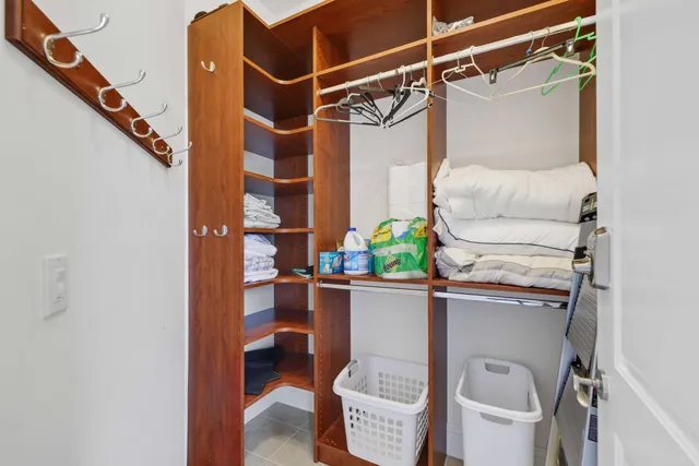 a view of walk in closet with wooden floor