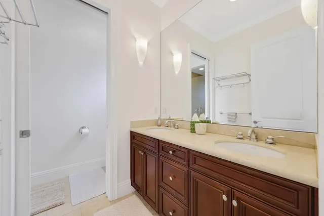 a spacious bathroom with a granite countertop sink and a mirror