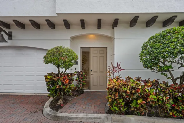 a vase of flowers sitting on a wooden floor