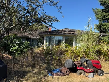 a view of a house with a tree in the background