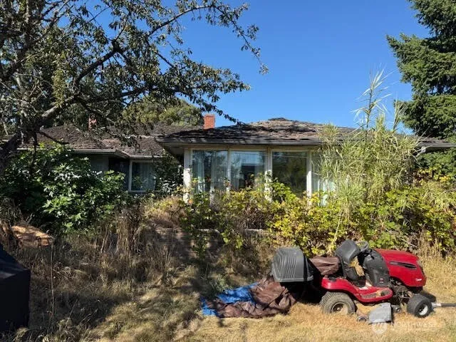 a view of a house with a tree in the background