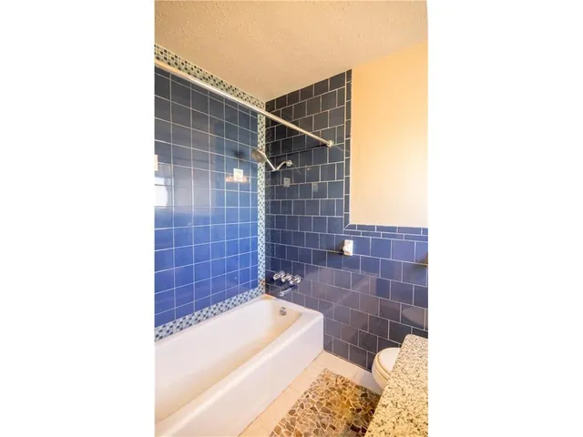 a bathroom with a bathtub and shower