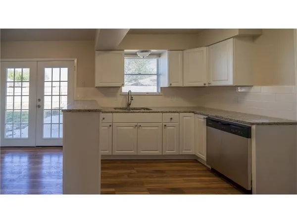 a kitchen with a sink cabinets and window