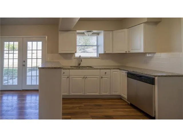 a kitchen with a sink cabinets and window
