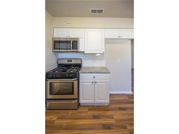 a kitchen with a stove and a microwave