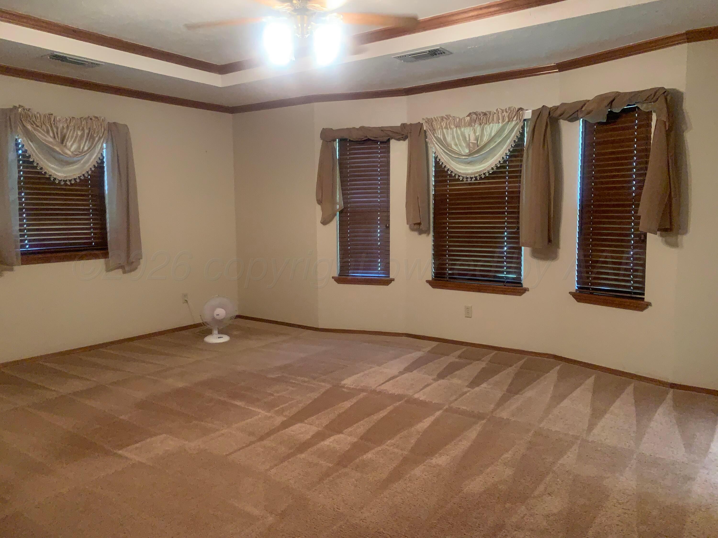 6101 Ridgewood Drive Amarillo, TX 79109 - Photo 15 of 28 a view of an empty room with wooden floor and a window