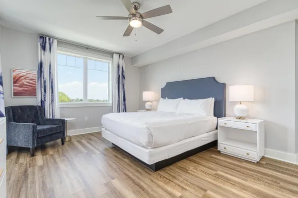 a bedroom with a bed flat screen tv and a window