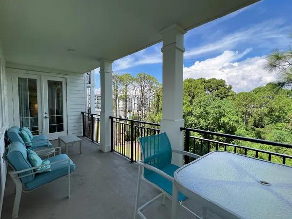 a balcony with table and chairs