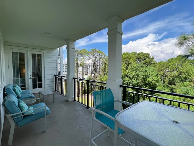 a balcony with table and chairs