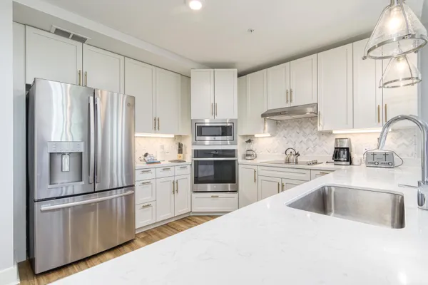 a kitchen with a sink stove and cabinets