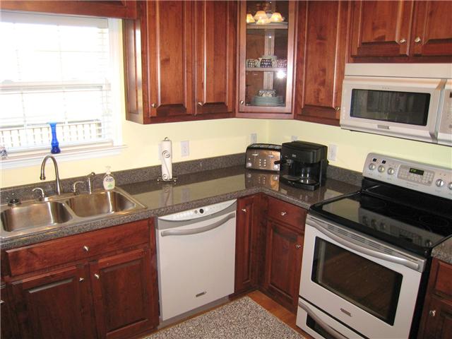 2001 Lasea Way Spring Hill, TN 37174 - Photo 6 of 20 Kitchen with Cherry Stained Cabinets, Smoothtop Range and Microwave Oven.