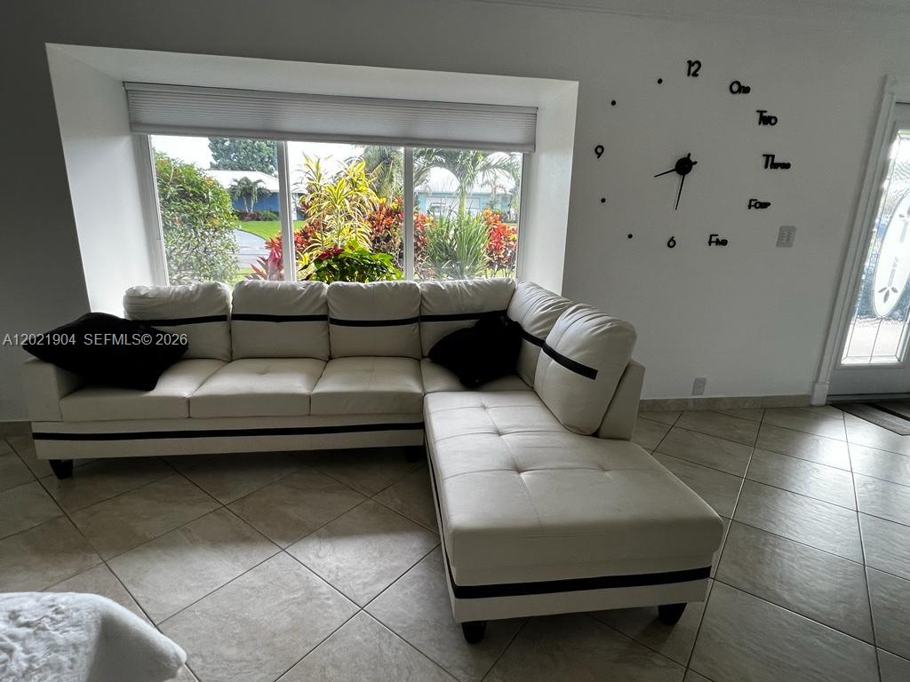 3324 Lakeview Boulevard Delray Beach, FL 33445 - Photo 17 of 36 a living room with furniture and a large window