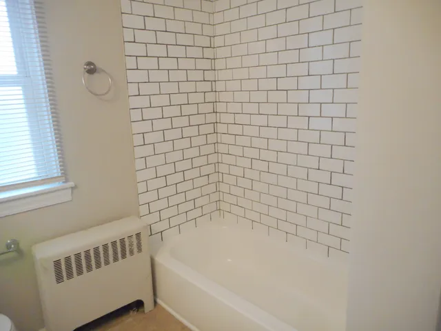 a bathroom with a bathtub and shower