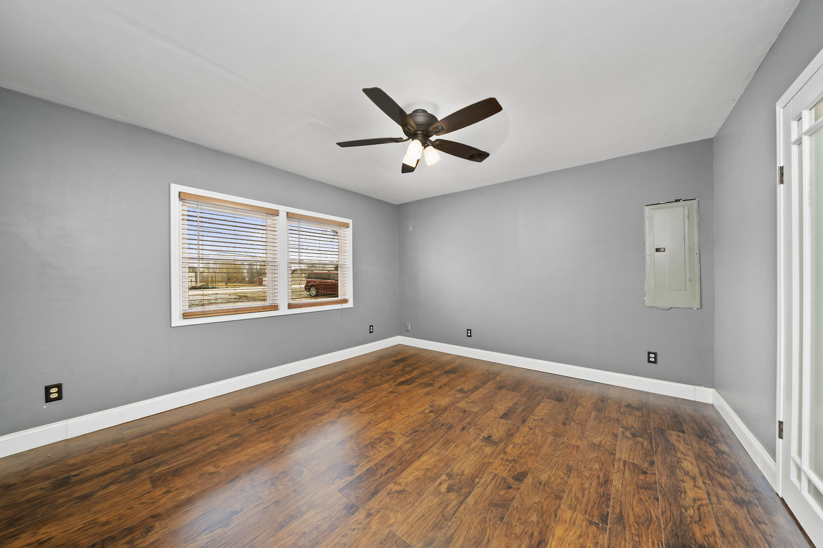 86 Bristol Ridge Road Bristol, IL 60512 - Photo 20 of 41 a view of an empty room with wooden floor and a window
