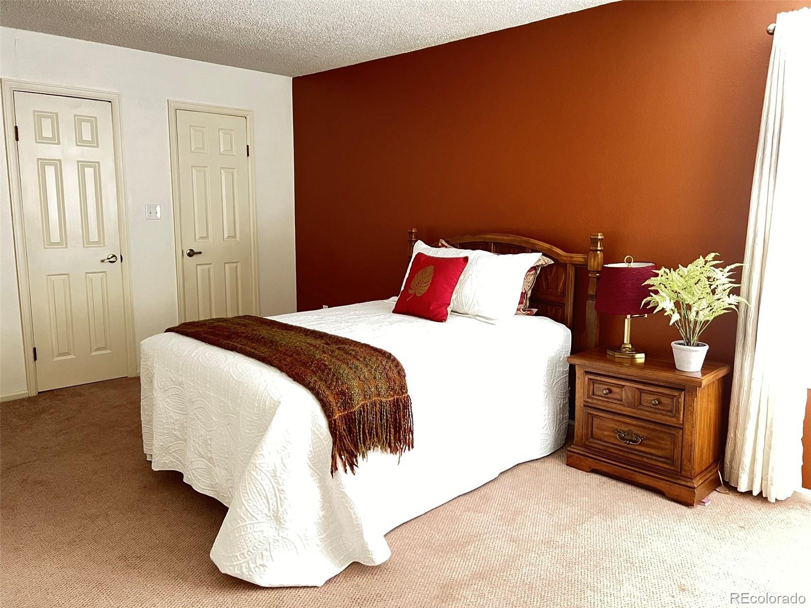 8488 Everett Way, Unit A Arvada, CO 80005 - Photo 12 of 27 a spacious bedroom with a bed and dresser