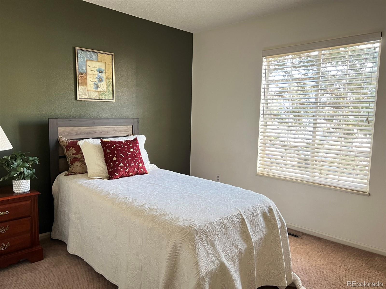 8488 Everett Way, Unit A Arvada, CO 80005 - Photo 19 of 27 a bedroom with a bed and a window