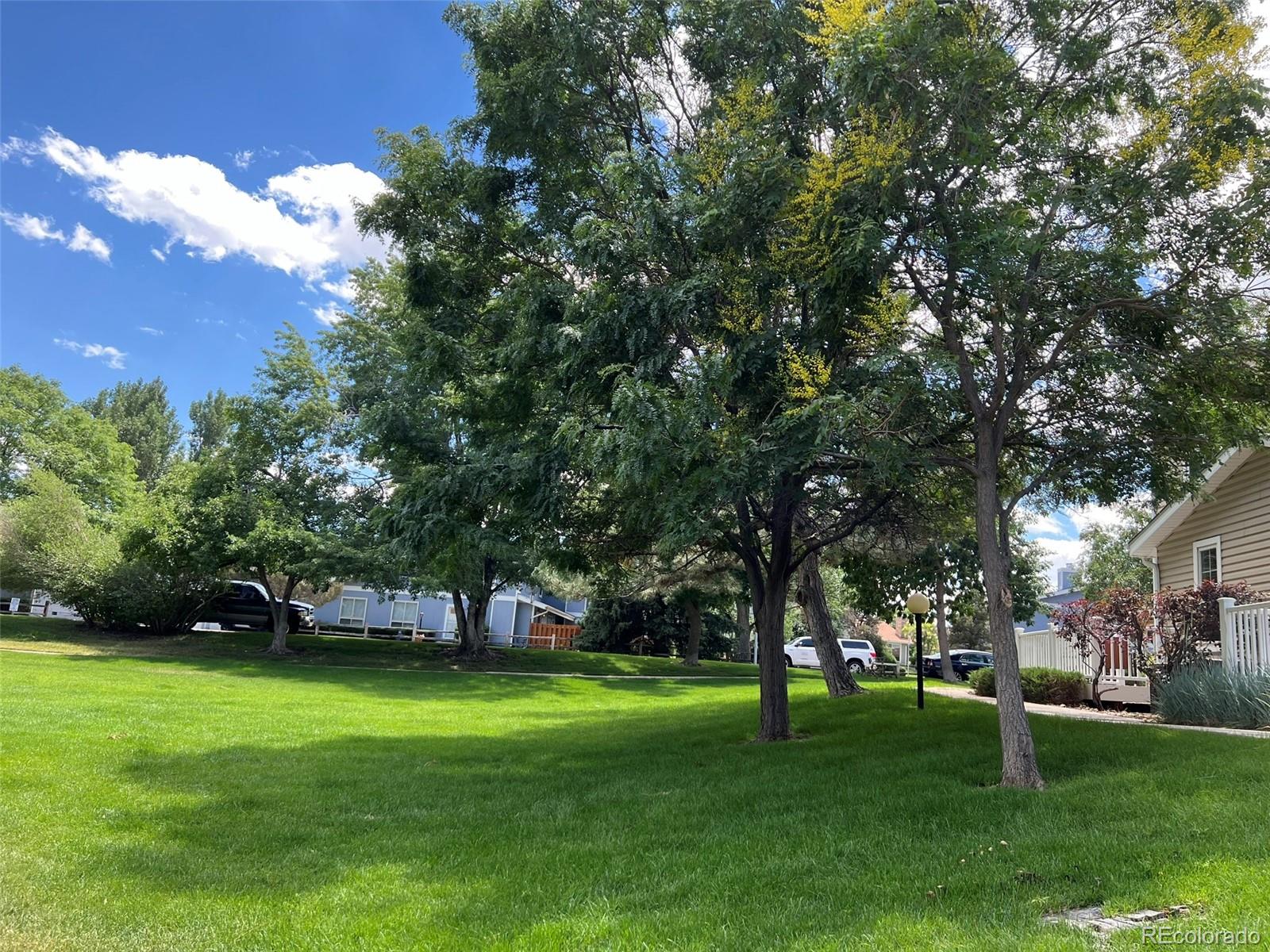 8488 Everett Way, Unit A Arvada, CO 80005 - Photo 24 of 27 a view of yard with swimming pool and green space