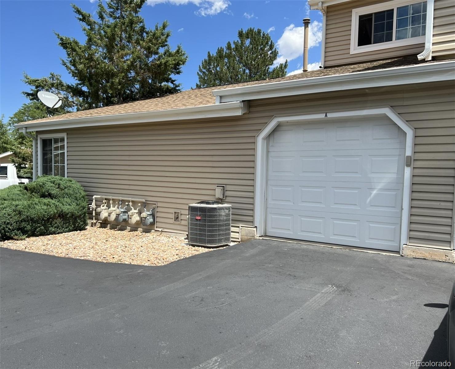 8488 Everett Way, Unit A Arvada, CO 80005 - Photo 25 of 27 a view of a house with a garage