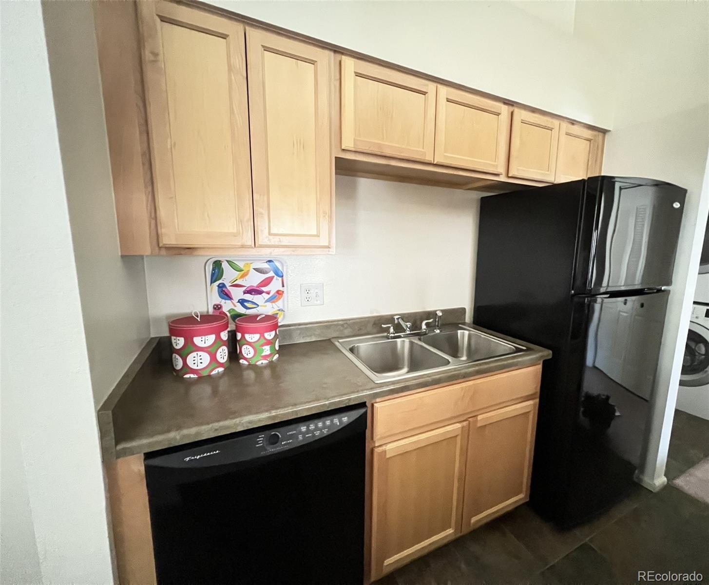 8488 Everett Way, Unit A Arvada, CO 80005 - Photo 9 of 27 a kitchen with a sink appliances and cabinets