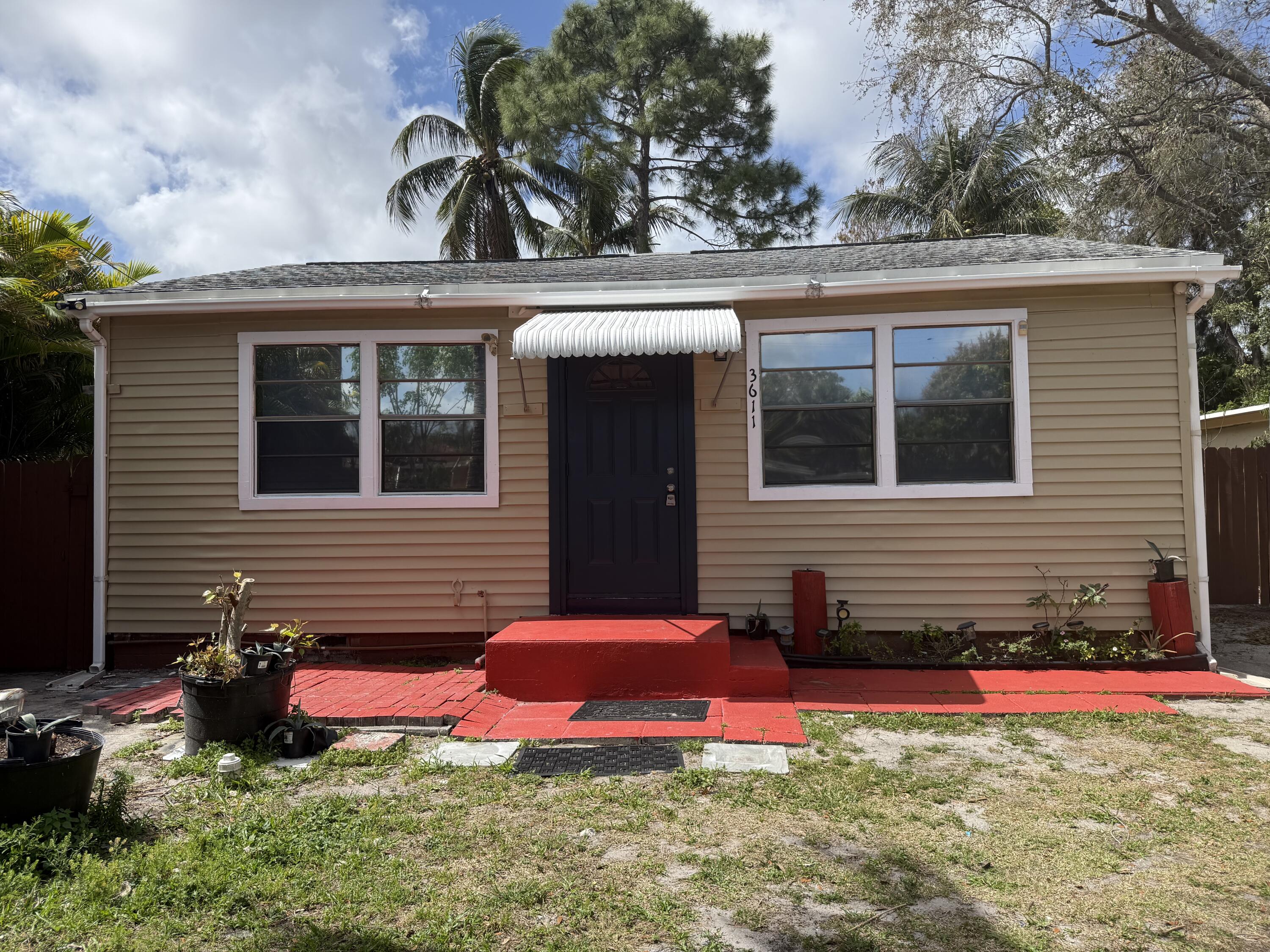 a view of a house with yard and sitting area