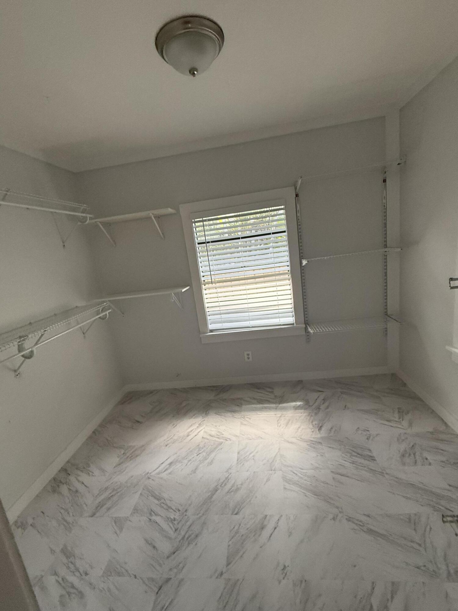 3611 Elizabeth Street Palm Springs, FL 33461 - Photo 13 of 19 an empty room with windows and natural light