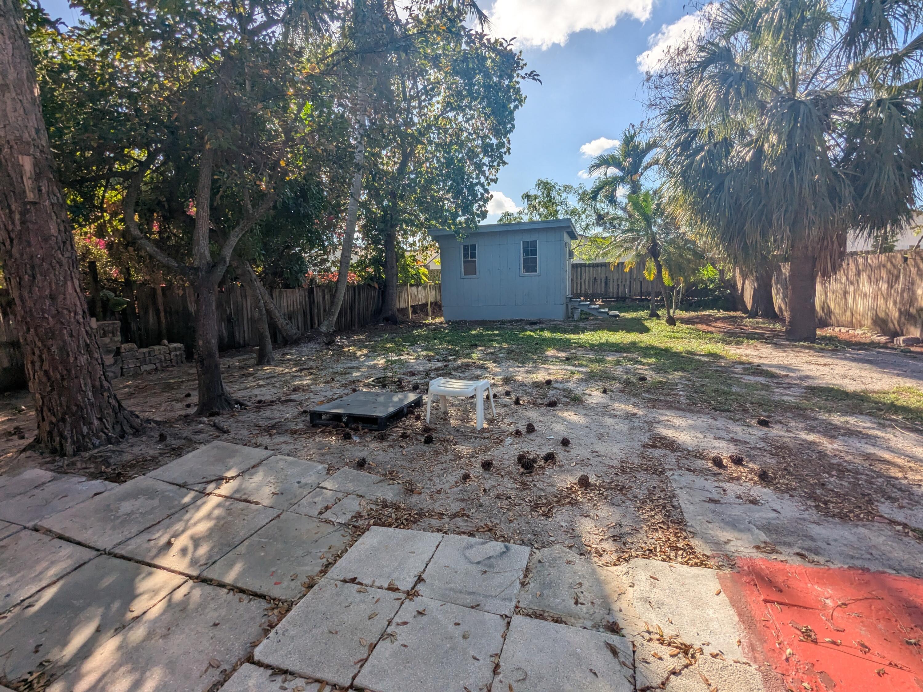 3611 Elizabeth Street Palm Springs, FL 33461 - Photo 18 of 19 a view of a backyard with trees and plants