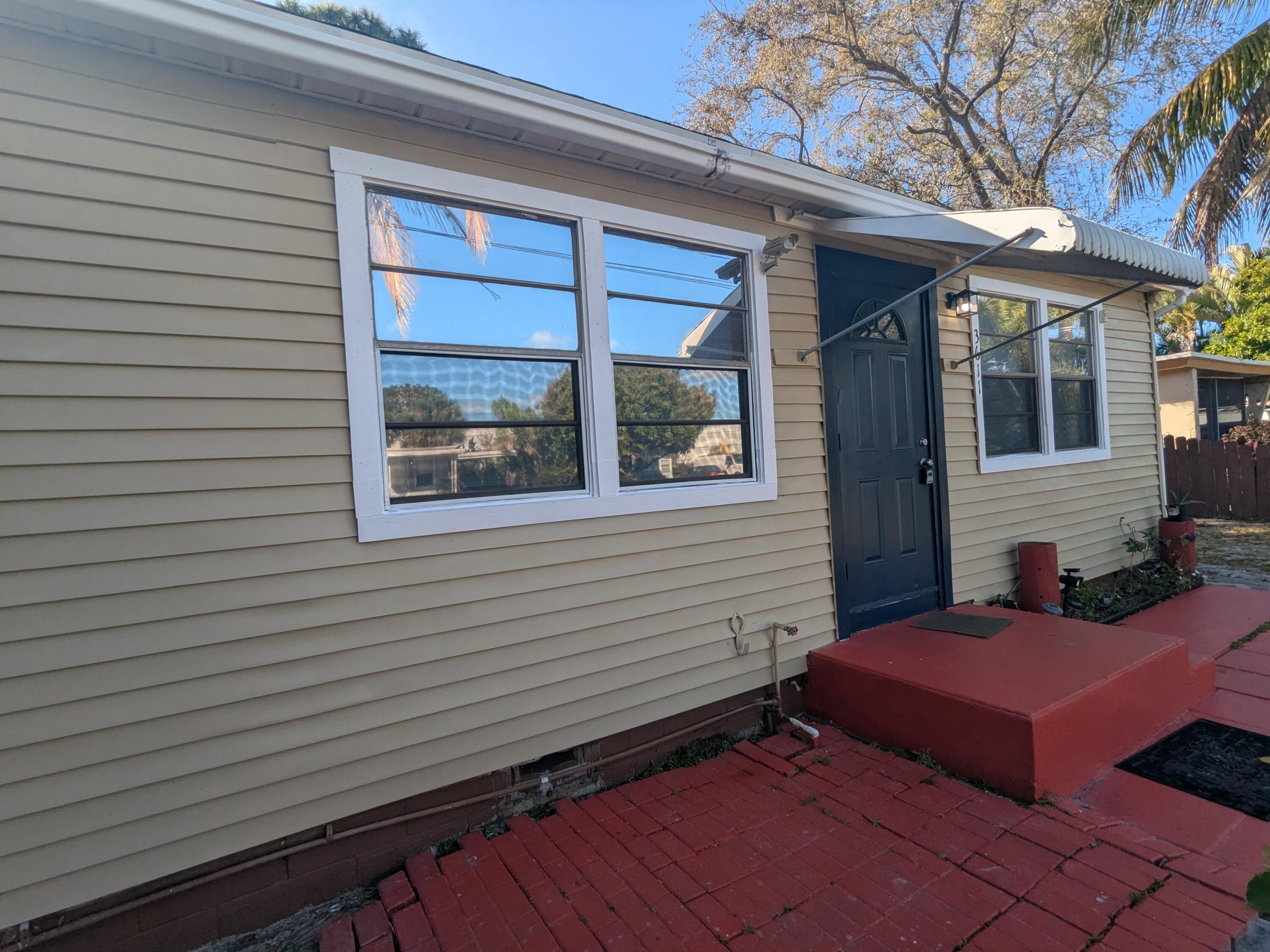 3611 Elizabeth Street Palm Springs, FL 33461 - Photo 2 of 19 a view of a house with a door and a yard