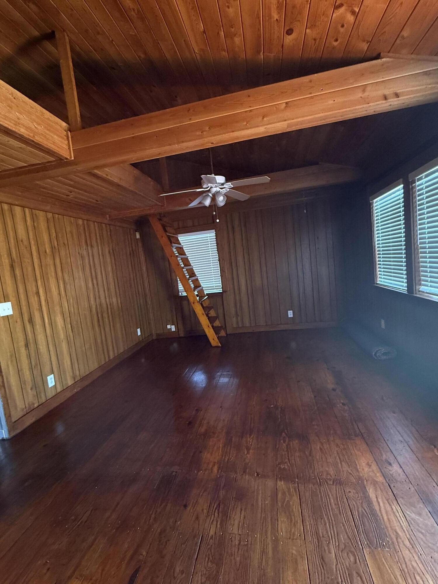 3611 Elizabeth Street Palm Springs, FL 33461 - Photo 7 of 19 a view of an empty room with wooden floor