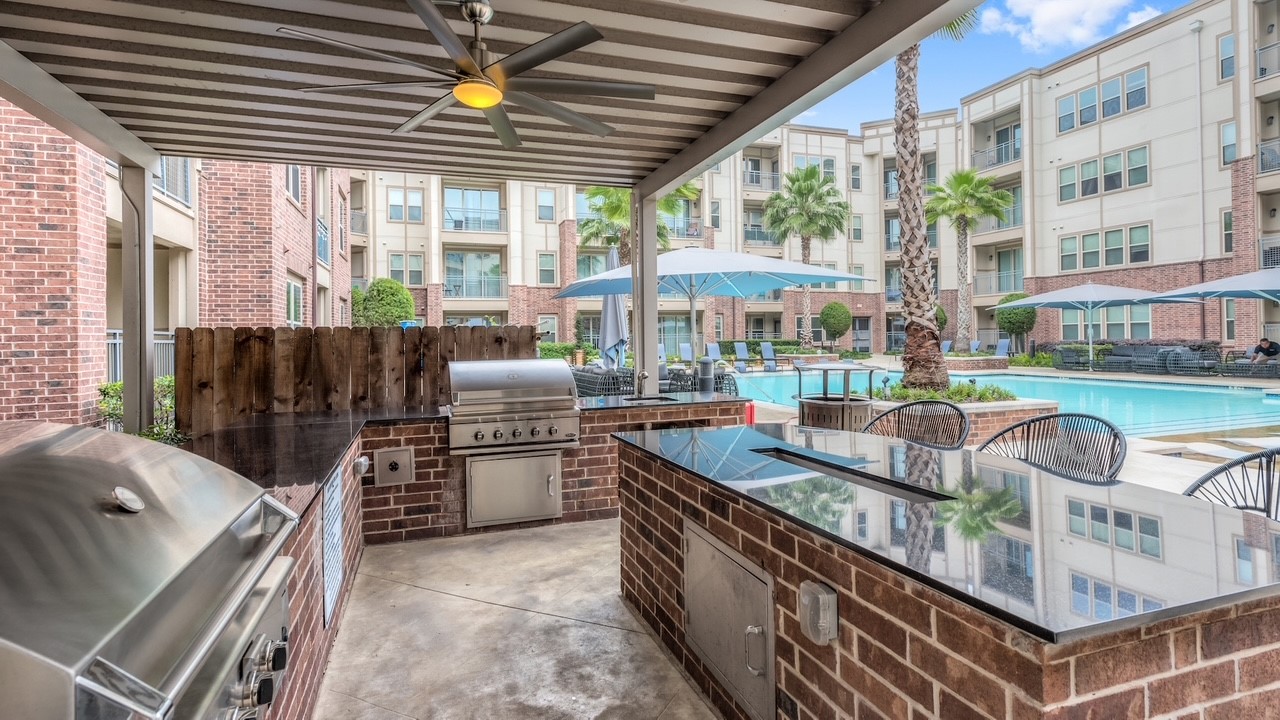 145 Heights Boulevard, Unit 229 Houston, TX 77007 - Photo 11 of 12 a kitchen with stainless steel appliances granite countertop a stove a sink and a refrigerator