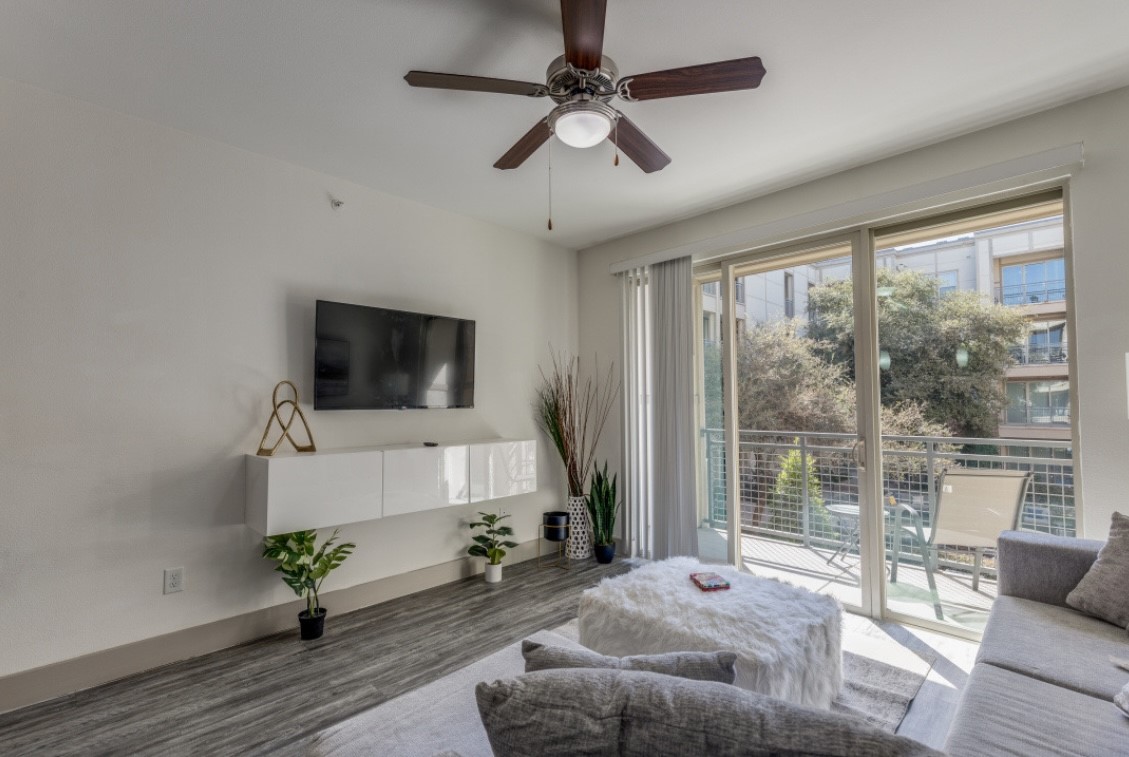 145 Heights Boulevard, Unit 229 Houston, TX 77007 - Photo 2 of 12 a living room with furniture and a flat screen tv