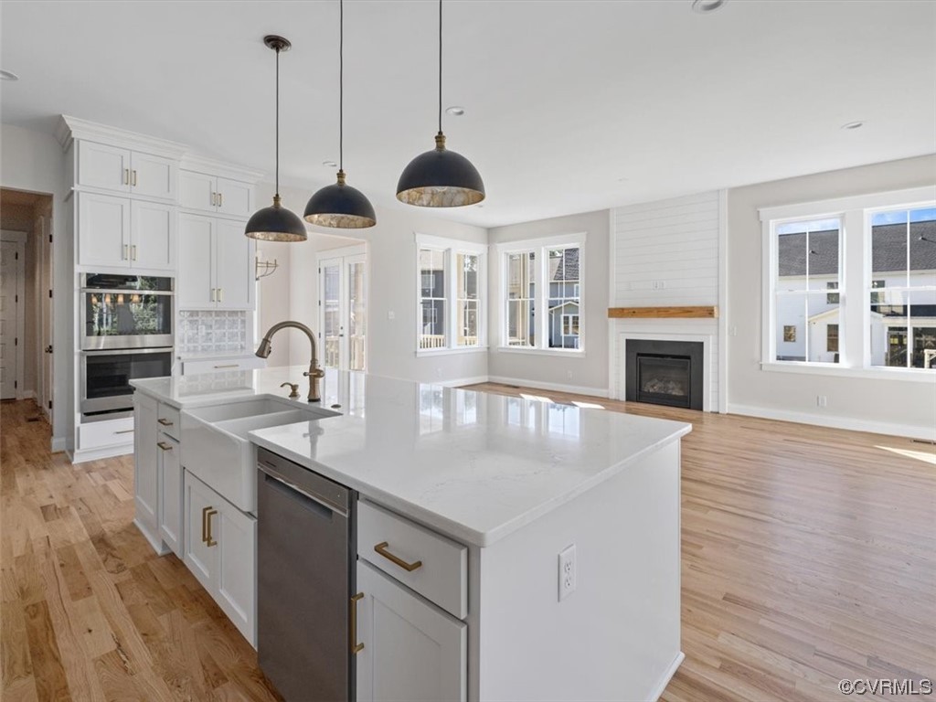 10708 River Fall Path Glen Allen, VA 23059 - Photo 11 of 35 a kitchen with stainless steel appliances granite countertop a sink a stove and a wooden floors