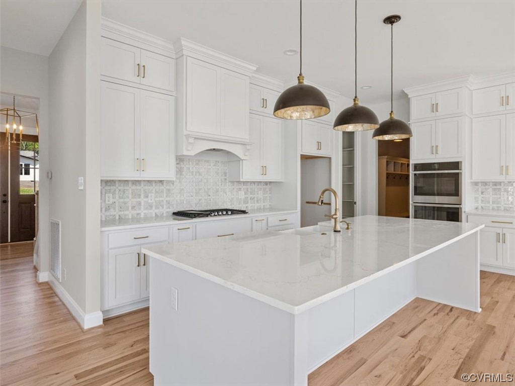 10708 River Fall Path Glen Allen, VA 23059 - Photo 12 of 35 a kitchen with a sink a center island stainless steel appliances and cabinets