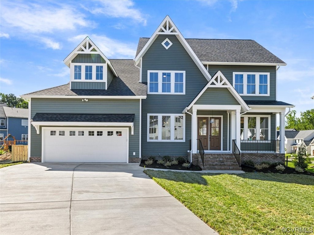10708 River Fall Path Glen Allen, VA 23059 - Photo 2 of 35 a front view of a house with a yard and garage