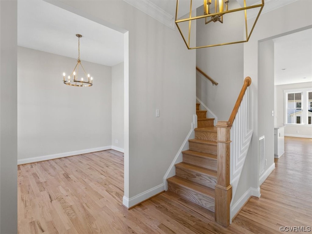 10708 River Fall Path Glen Allen, VA 23059 - Photo 5 of 35 a view of a hallway with stairs and wooden floor