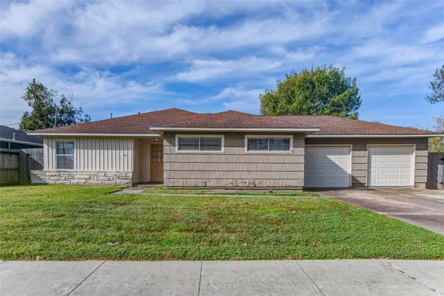 a backyard of a house with yard and garage