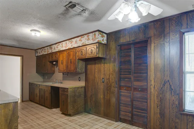 a view of hallway with a sink and wooden floor