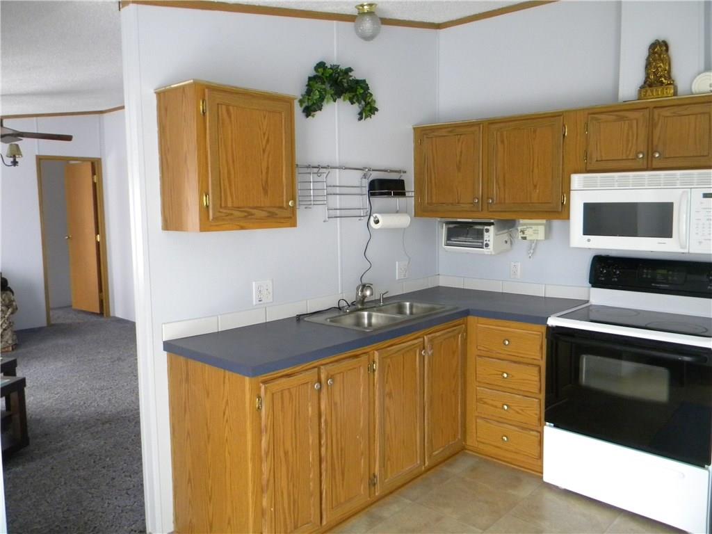 664 County Line Road Acme, PA 15610 - Photo 2 of 24 Cute kitchen come equipped with stove, refrigerator, and microwave.
