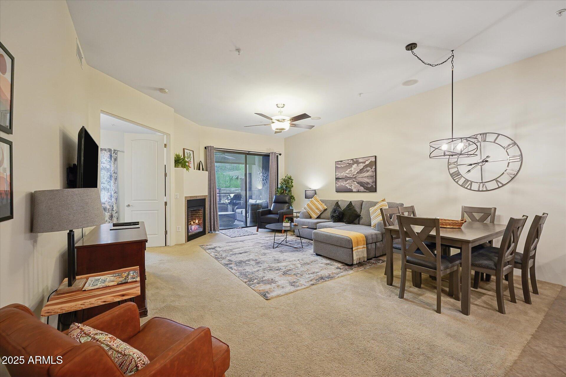 36600 North Cave Creek Road, Unit D6 Cave Creek, AZ 85331 - Photo 11 of 25 a living room with furniture a rug and a chandelier