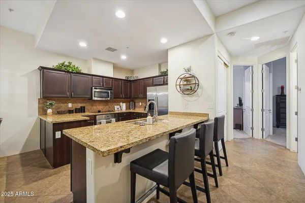 a kitchen with a table and chairs in it