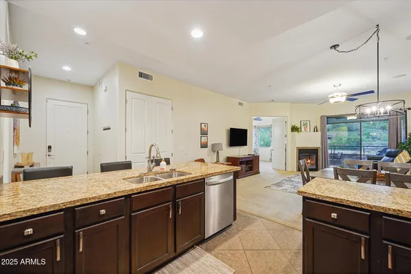a spacious bathroom with a granite countertop sink and a large mirror