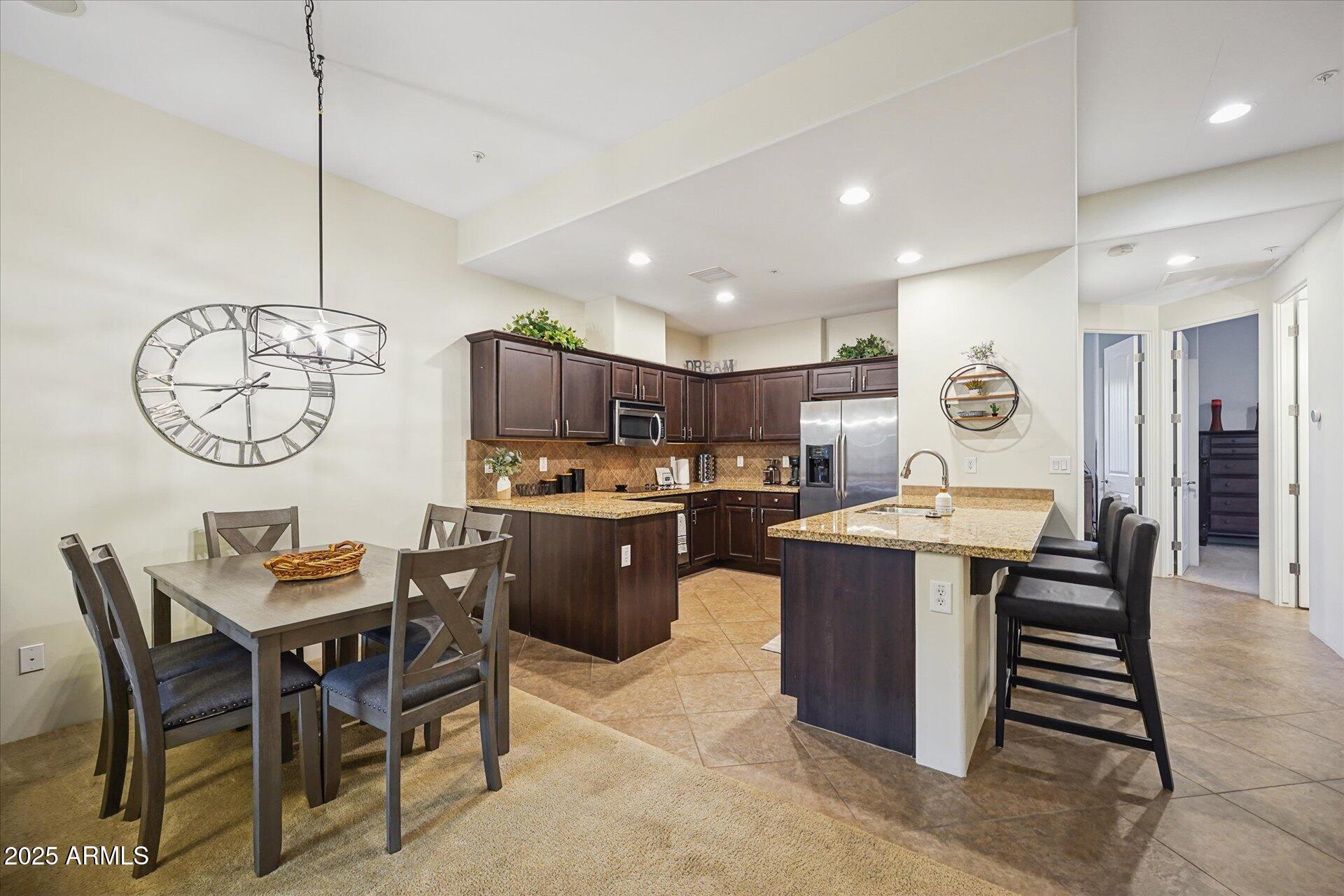 36600 North Cave Creek Road, Unit D6 Cave Creek, AZ 85331 - Photo 10 of 25 a kitchen with a table and chairs in it