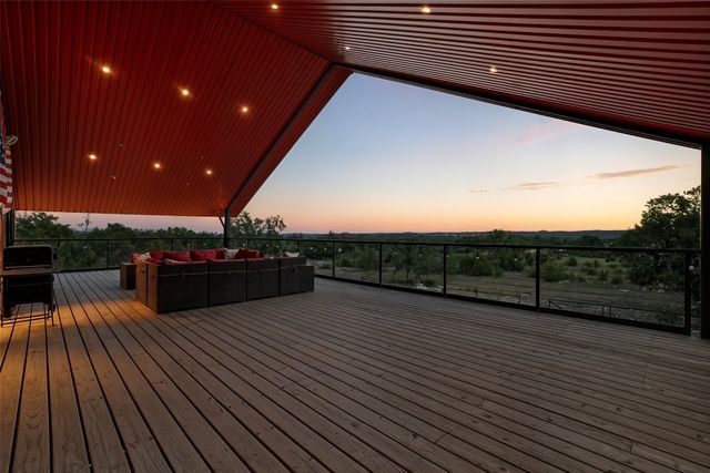 a view of a terrace with wooden floor and fence