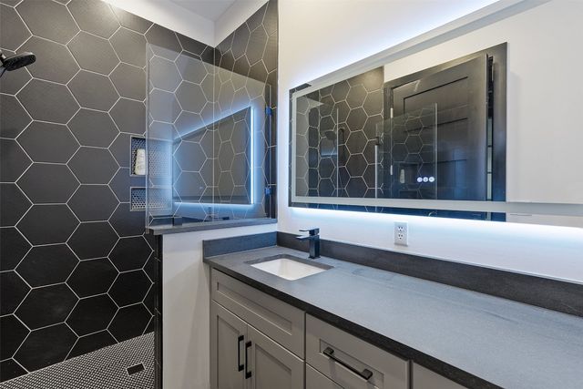 a bathroom with a sink and a mirror