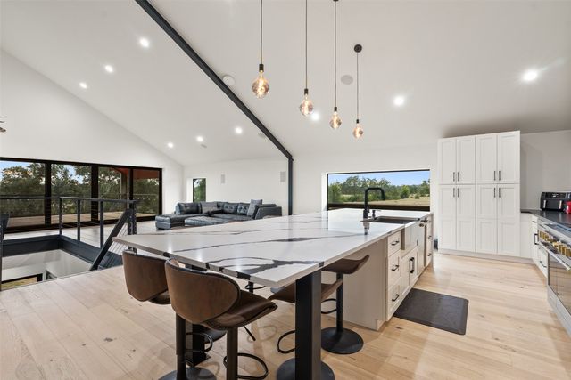 a living room with stainless steel appliances kitchen island granite countertop furniture and a view of living room