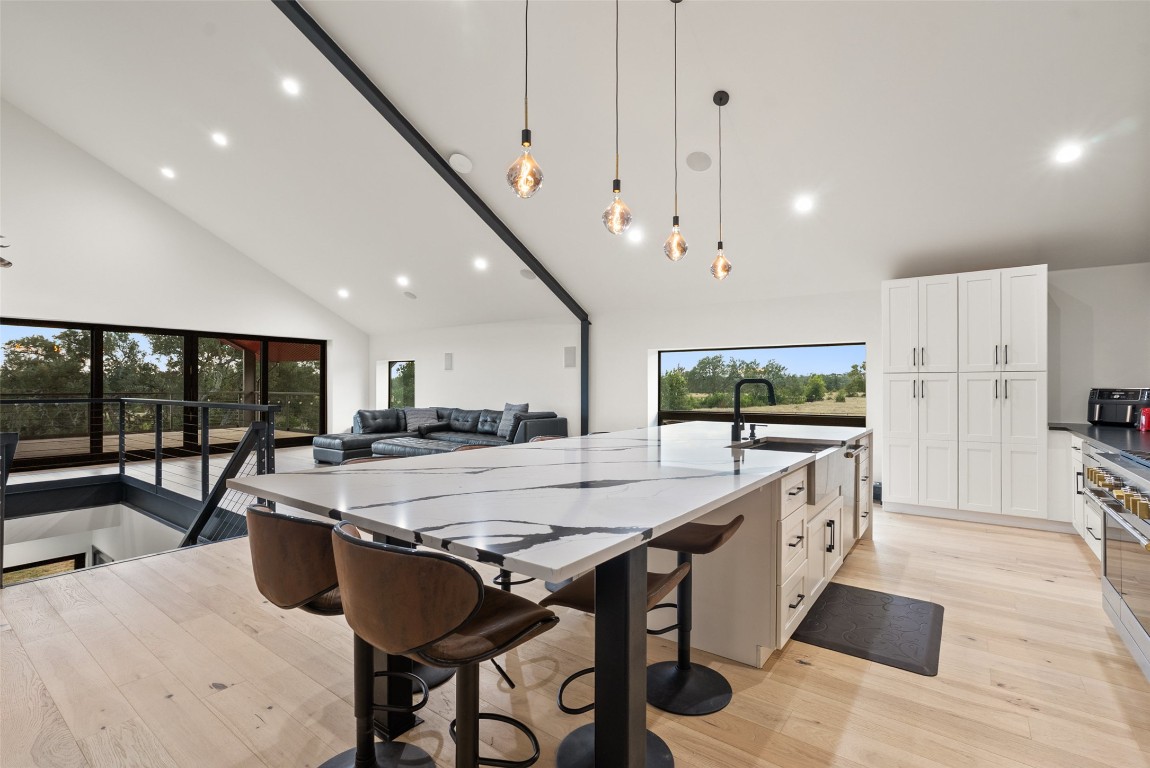 561 Broken Bit Trail Dripping Springs, TX 78620 - Photo 8 of 40 a large kitchen with a table and chairs