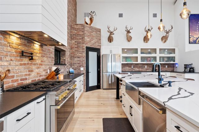 a large kitchen with a table and chairs