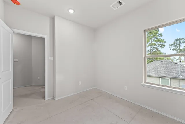 an empty room with large windows