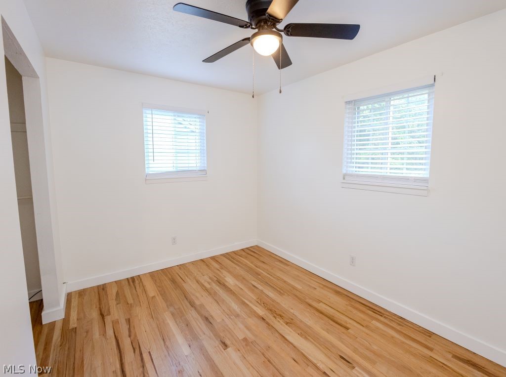 8828 Edgehill Road Mentor, OH 44060 - Photo 19 of 24 Unfurnished bedroom featuring multiple windows, ceiling fan, and light hardwood / wood-style flooring
